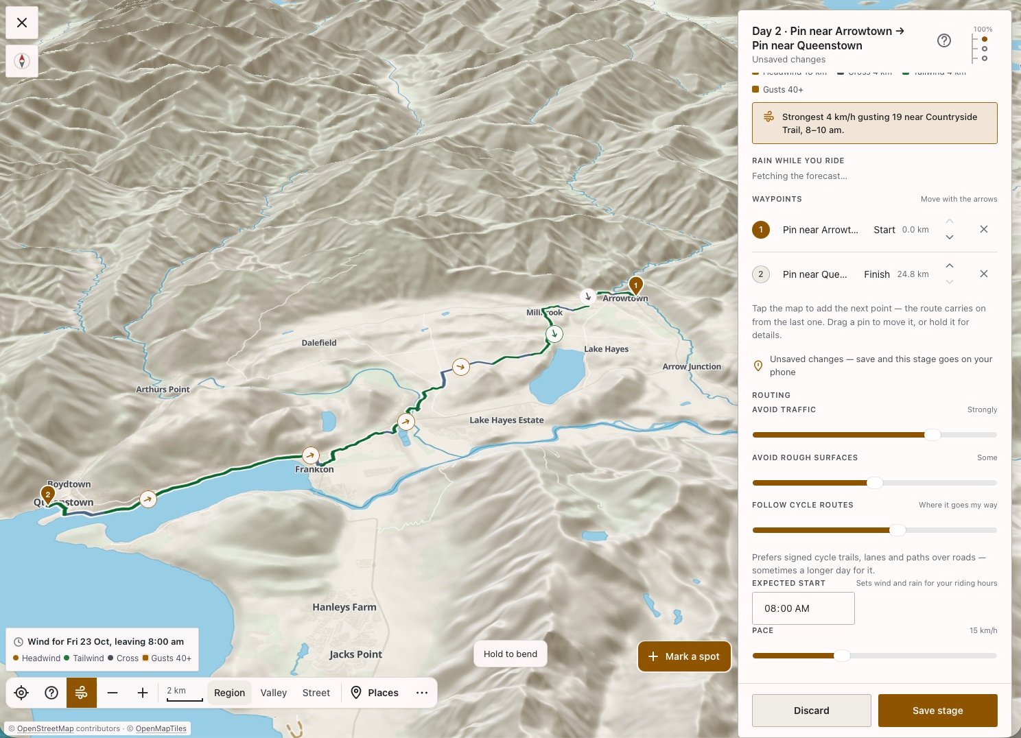The stage planner in 3D: a day from Arrowtown to Queenstown along the trail, with wind arrows on the route and sliders to avoid traffic, avoid rough surfaces and follow cycle routes